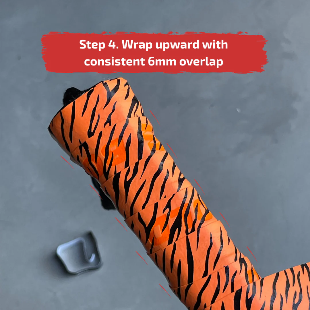 Wrapping the overgrip upward around the padel racket handle